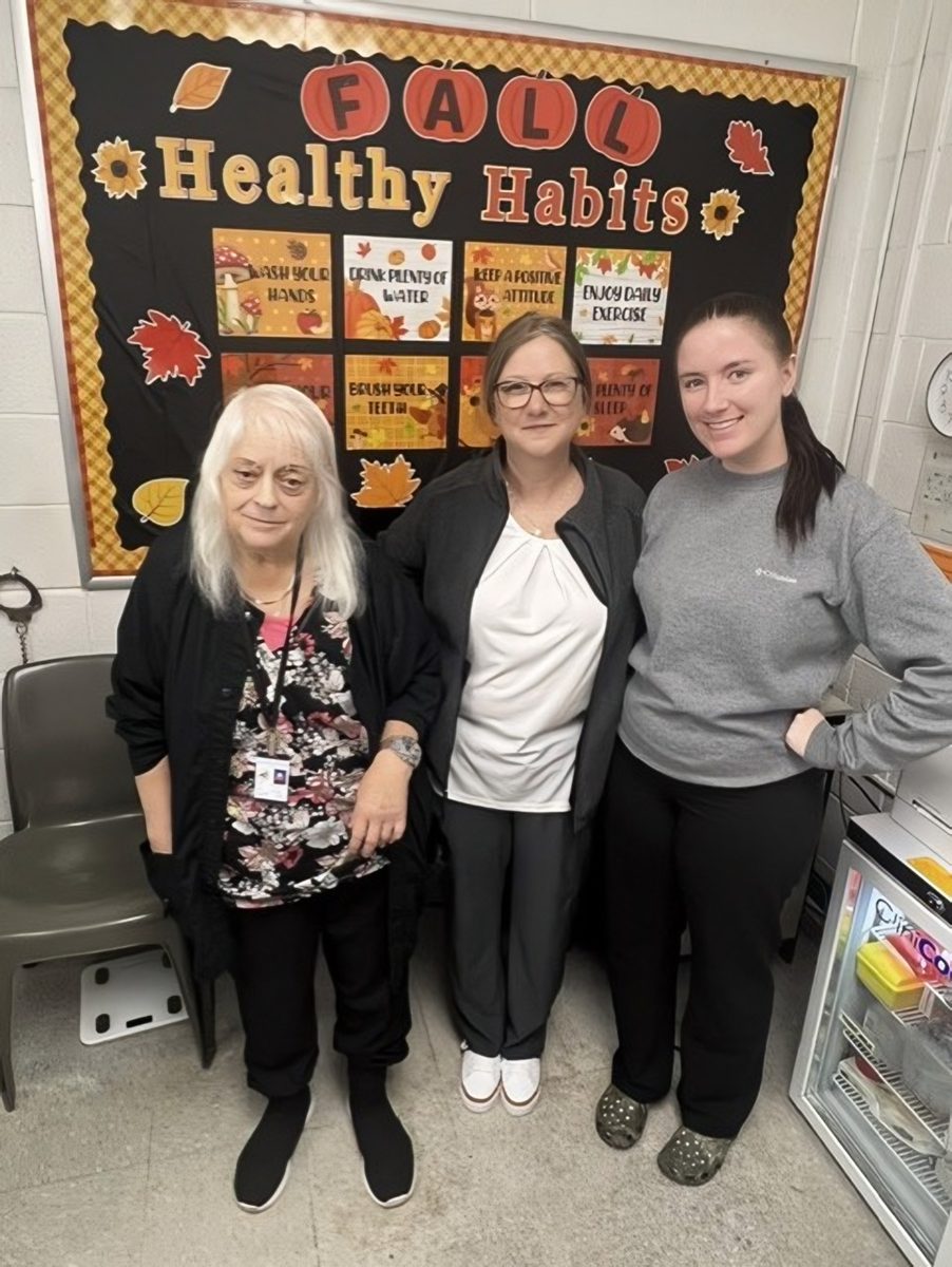 Three members of the CBH Medical team standing in front of a Fall Healthy Habits health education board