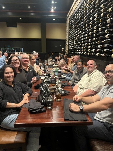 CBH Medical team members and Virginia regional jail leaders seated together along a long dinner table